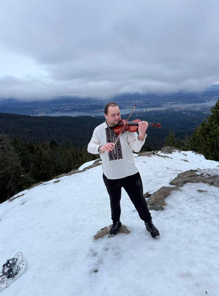 Playing violin in the mountains